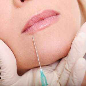 close-up-hands-cosmetologist-making-botox-injection-female-lips_144627-283